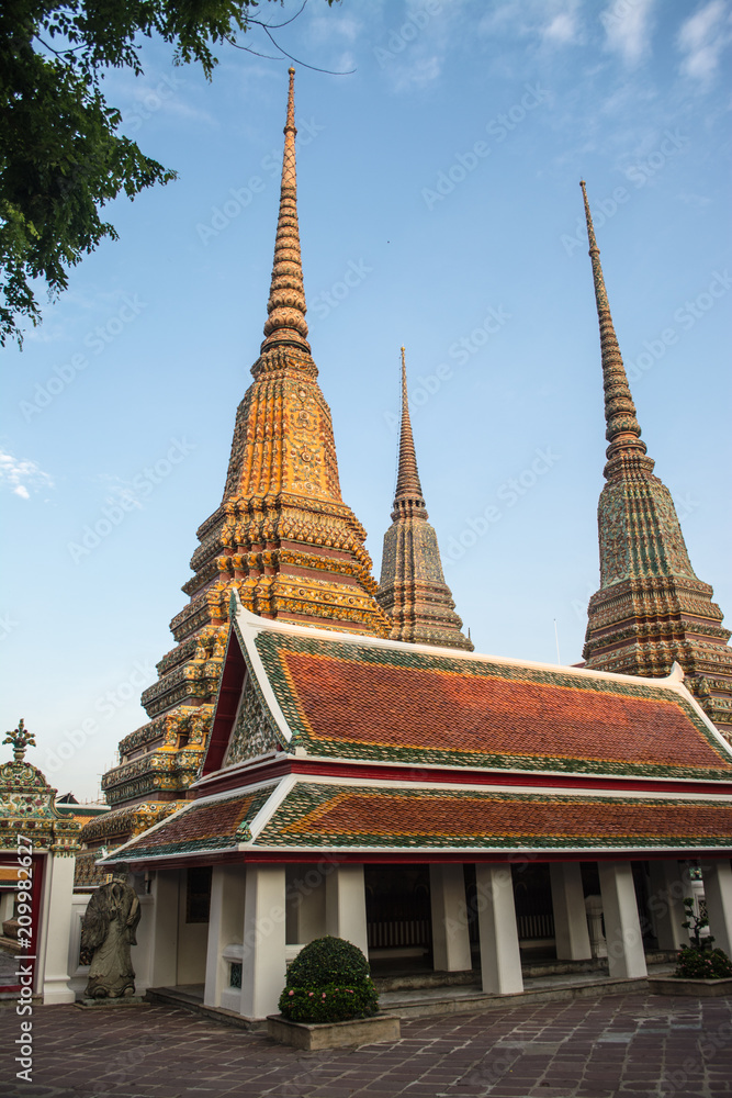 Fototapeta premium Pagoda is in Wat Pho that was named as the temple of the pagoda or chedi that are decorated with yellow glaze or glazed tiles or dark blue. 