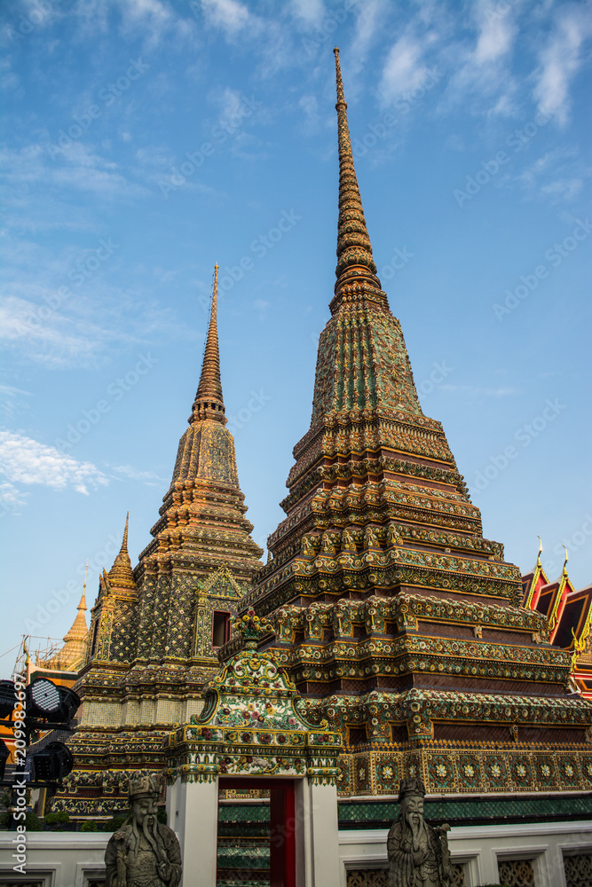Fototapeta premium Pagoda is in Wat Pho that was named as the temple of the pagoda or chedi that are decorated with yellow glaze or glazed tiles or dark blue. 