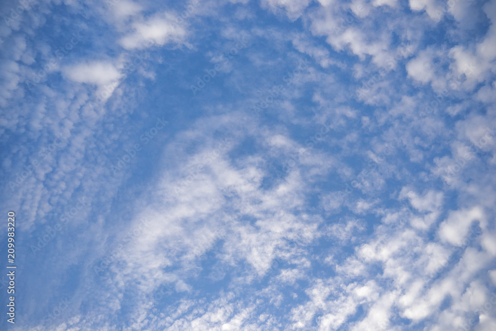 Blue sky with clouds. Scattered white clouds in the blue sky for text background.  