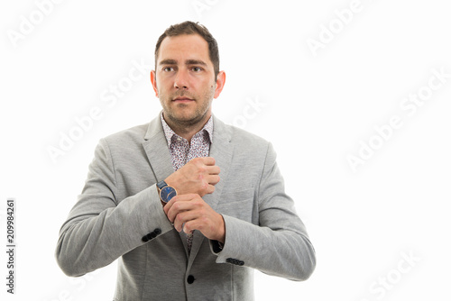 Slika na platnu Portrait of business man arranging his sleeve