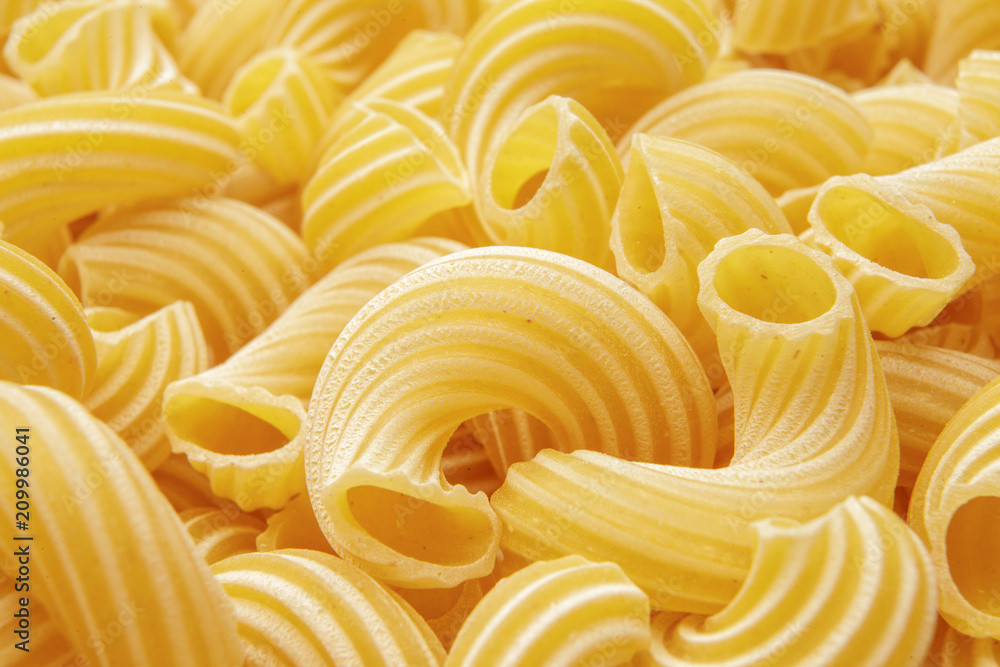 background of pasta in the form of tubes spun in a spiral background of pasta in the form of tubes spun in a spiral