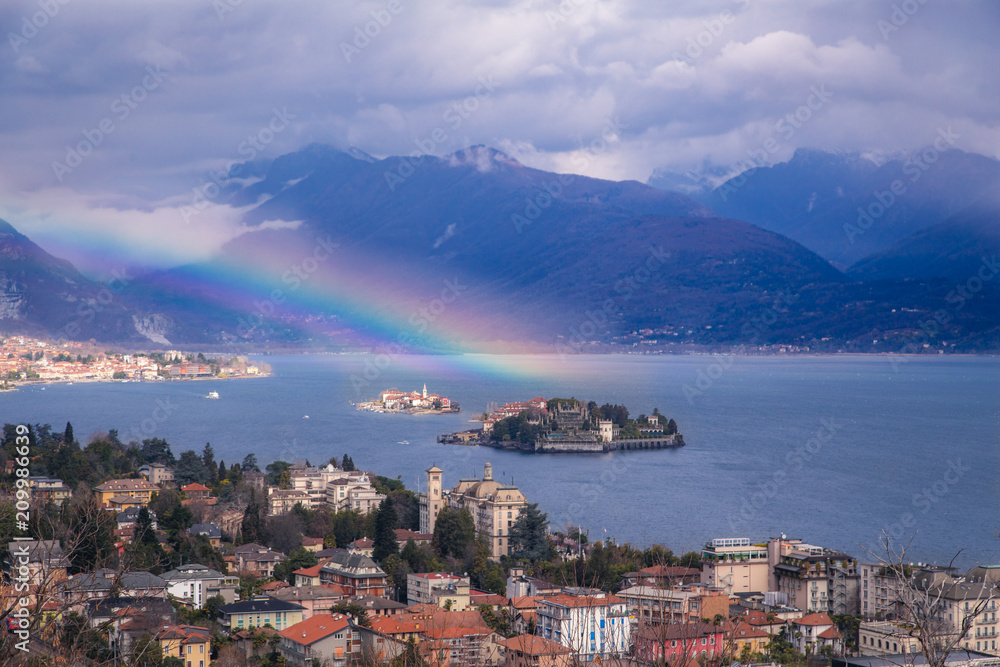 The panoramic view of city Stresa and Lago Magorre with rainbow