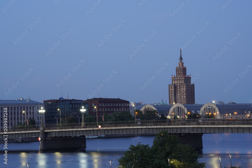 Fototapeta premium Landscape of a bridge in Riga, Latvia and the Daugava river at night