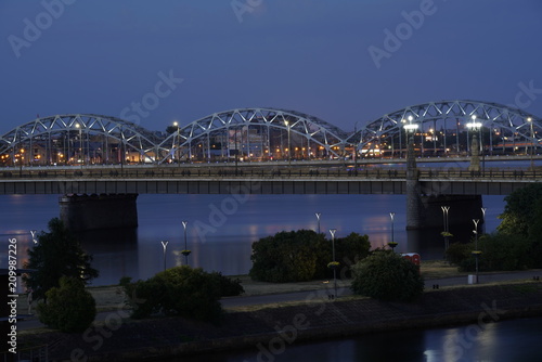 Landscape of a bridge in Riga, Latvia and the Daugava river at night © Eduards