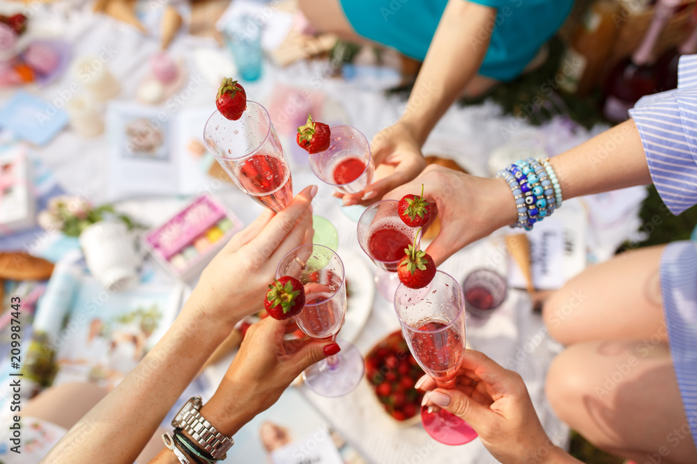Hands with glasses cheers on summer day picnic Hands with glasses cheers on summer day picnic
