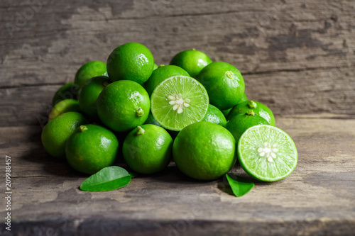 Limes on old wooden background