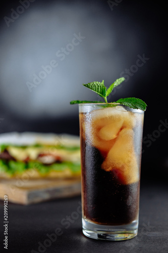drink cocktail of cola with ice, mint and big sandwich Street food, fast food. Homemade burgers with beef