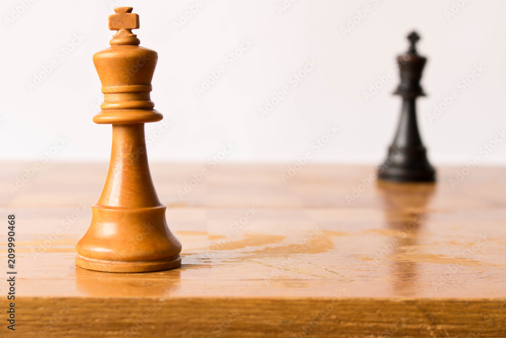 Confrontation between the white and black chess king. Chess game concept Confrontation between the white and black chess king. Chess game concept