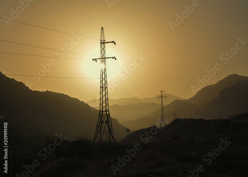 Electricity pylons  and mountains sunset
