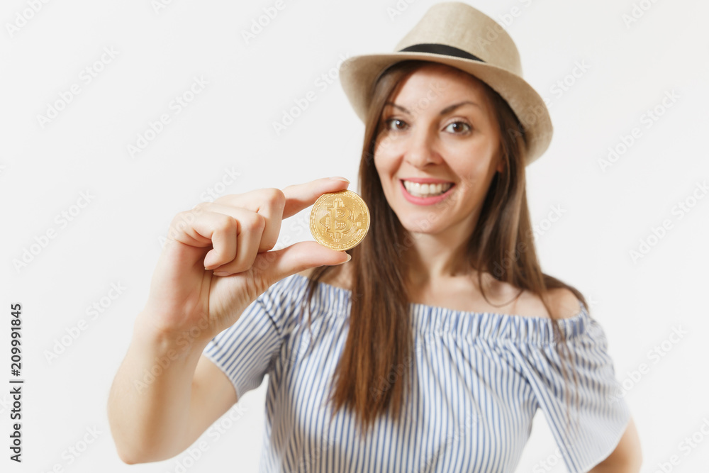 Young elegant woman in blue dress, hat with long hair holding bitcoin, coin of golden color isolated on white background. Finance, business, virtual currency concept. Advertising area. Copy space. Young elegant woman in blue dress, hat with long hair holding bitcoin, coin of golden color isolated on white background. Finance, business, virtual currency concept. Advertising area. Copy space.