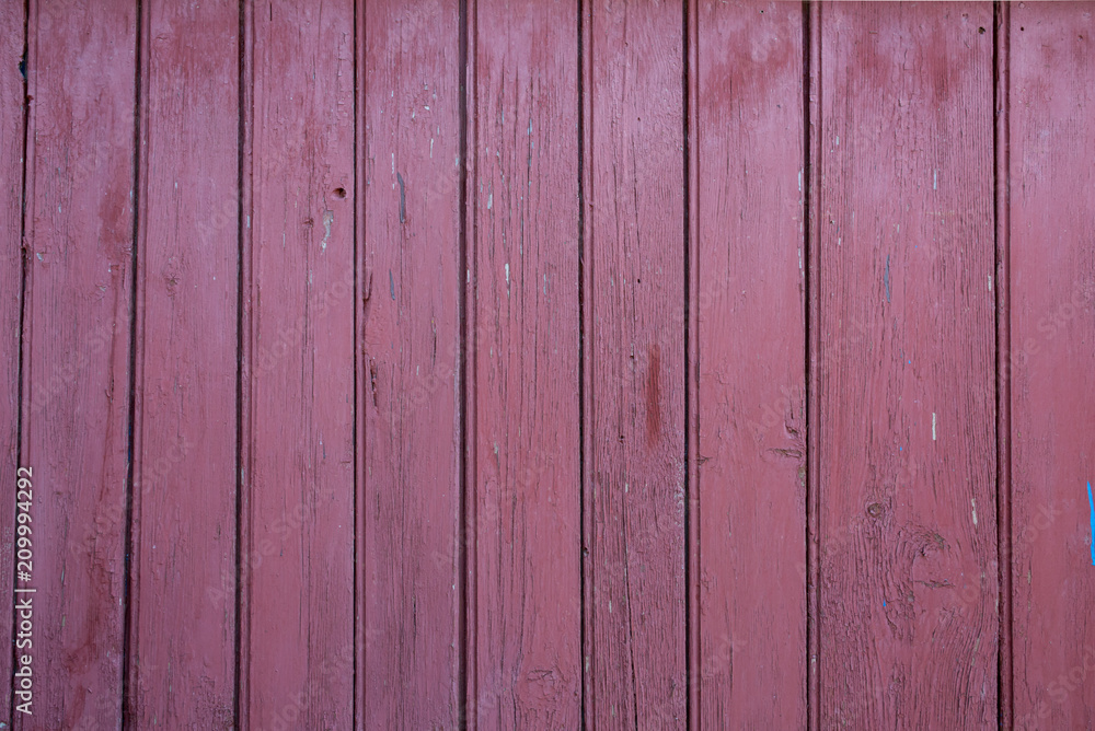 Naklejka premium Old vertical pink wooden planks outdoors. Vintage rustic background texture.