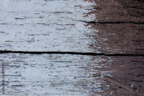 Peeling paint pattern on old wooden background. White and brown vintage rustic texture.
