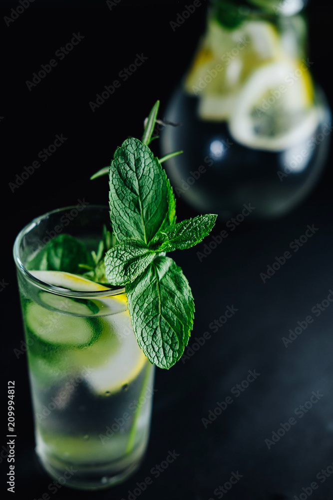 Fresh Summer Drink. Healthy glass detox fizzy water with lemon, mint,  rosemary and cucumber in mason jar over dark background. Healthy food  concept. Detox diet. Stock Photo | Adobe Stock