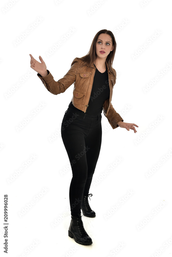 full length portrait of brunette girl wearing brown leather jacket. standing pose on white background. full length portrait of brunette girl wearing brown leather jacket. standing pose on white background.