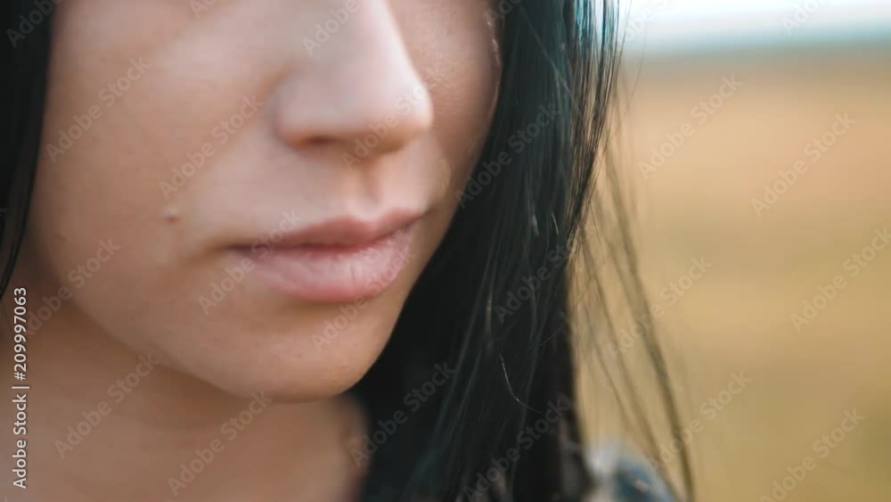 pretty girl brunette large lips wind develops hair portrait slow motion video. brunette woman girl hair hairstyle lips strong wind on the nature. girl lips lifestyle wind hair concept pretty girl brunette large lips wind develops hair portrait slow motion video. brunette woman girl hair hairstyle lips strong wind on the nature. girl lips lifestyle wind hair concept