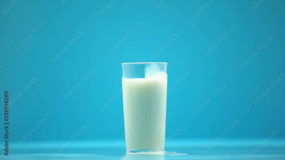 Hand pouring milk in glass on table, healthy nutrition, dairy product, breakfast Hand pouring milk in glass on table, healthy nutrition, dairy product, breakfast
