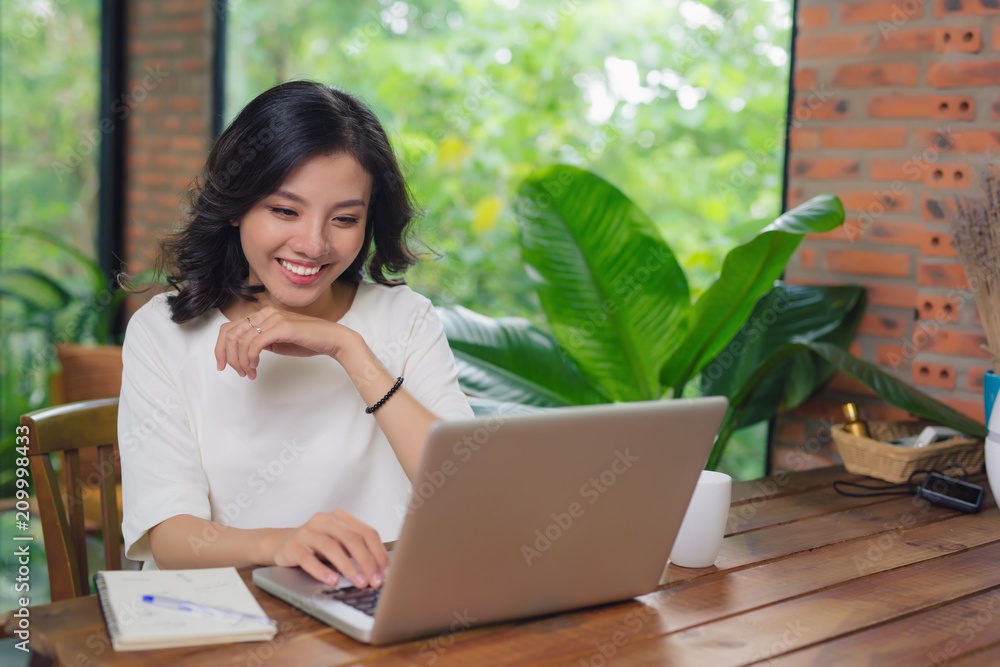 Happy Young Beautiful Woman Using Laptop, Indoors Happy Young Beautiful Woman Using Laptop, Indoors
