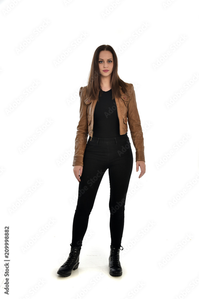 full length portrait of brunette girl wearing brown leather jacket. standing pose on white background. full length portrait of brunette girl wearing brown leather jacket. standing pose on white background.