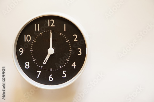 The indication of the wall clock of the room is 7:00