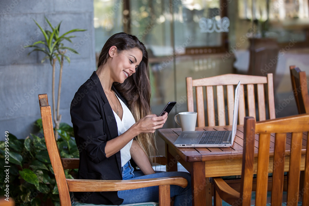 Cheerful businesswoman using phone in hotel Cheerful businesswoman using phone in hotel
