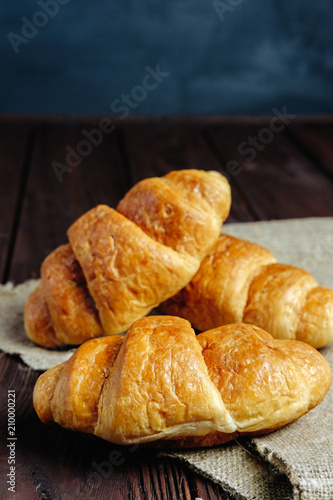 croissants on wooden table black background