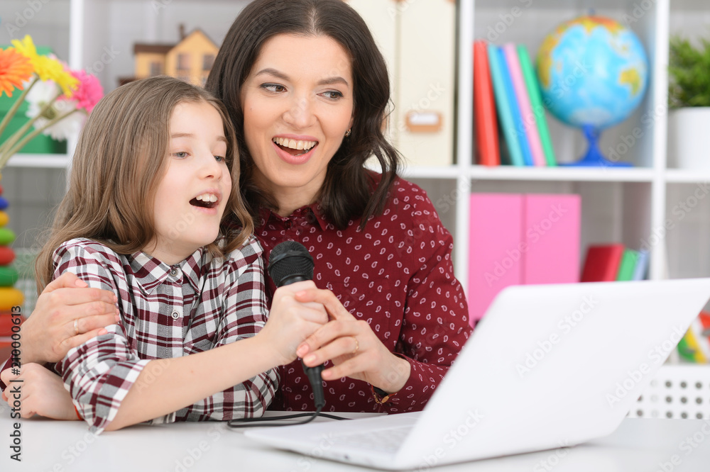 mother and daughter singing karaoke mother and daughter singing karaoke