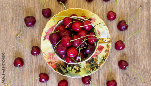 Fresh Cherry in a Cup on Wooden Background. Fresh Ripe Cherries. 