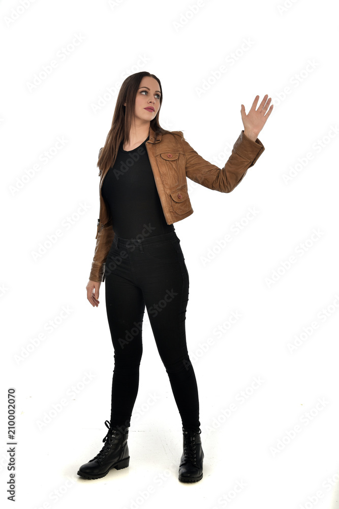 full length portrait of brunette girl wearing brown leather jacket. standing pose on white background. full length portrait of brunette girl wearing brown leather jacket. standing pose on white background.