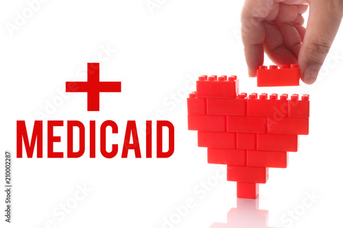 Medicaid, health conceptual. Hand help building heart, symbol of good health. photo