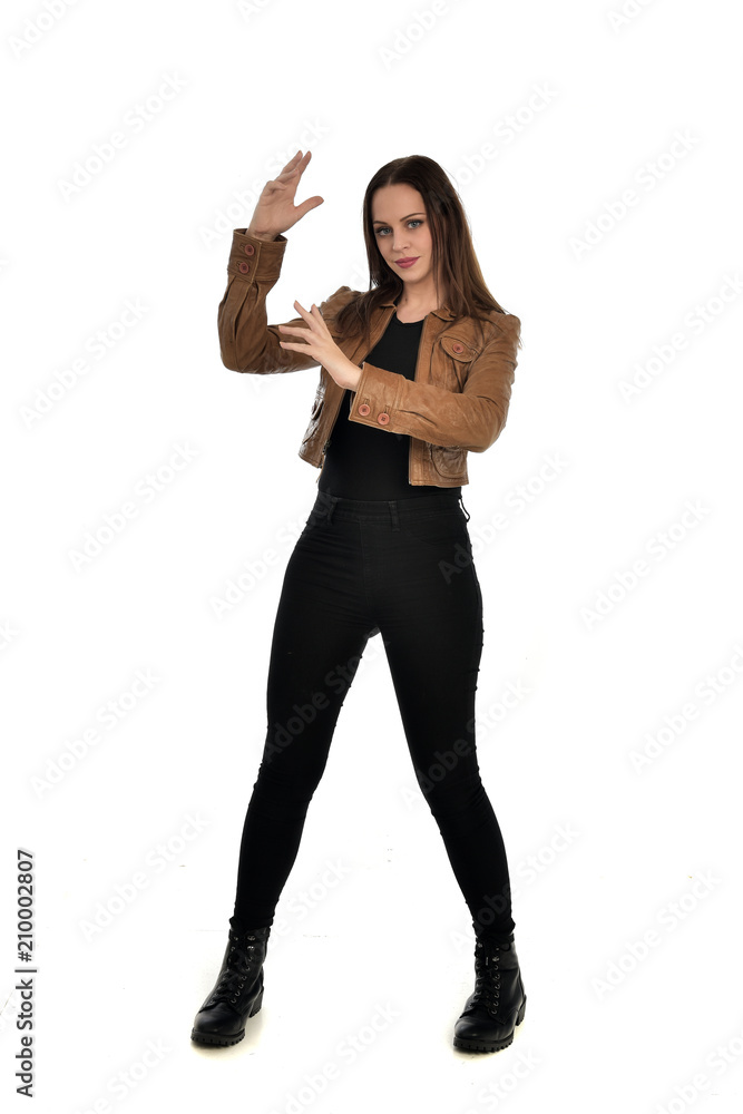 full length portrait of brunette girl wearing brown leather jacket. standing pose on white background. full length portrait of brunette girl wearing brown leather jacket. standing pose on white background.