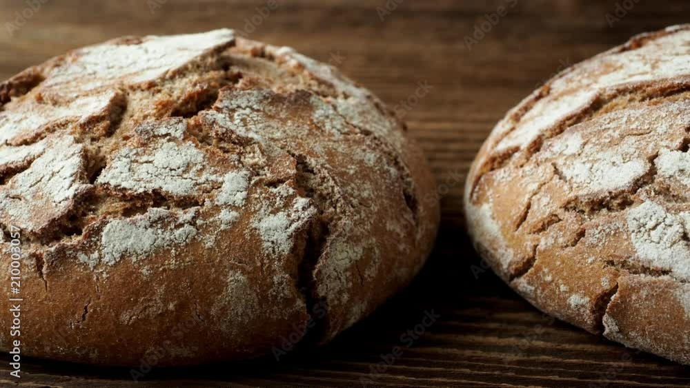 Delicious baked bread on a wooden background Delicious baked bread on a wooden background