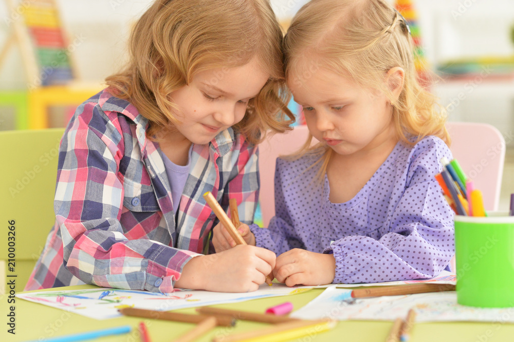 Cute little girls drawing with pencils Cute little girls drawing with pencils