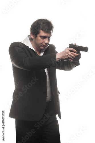 Handsome middle aged detective man with gun