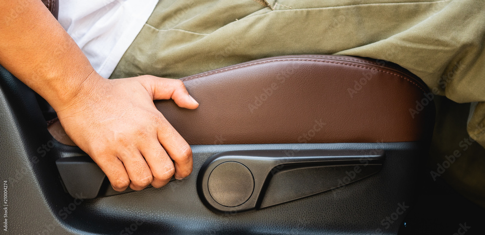 Hand holding on lever for Adjustable car seat. Hand holding on lever for Adjustable car seat.
