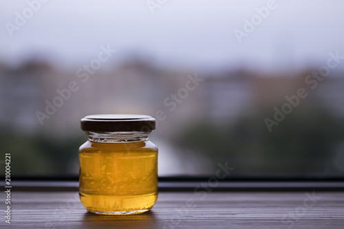 Honey in glass jar closeup, photo