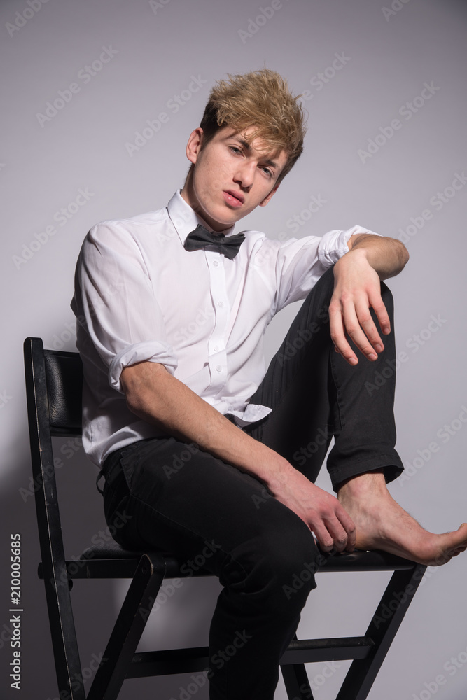 Fashion portrait of a man in a classic suit with a bow tie Fashion portrait of a man in a classic suit with a bow tie