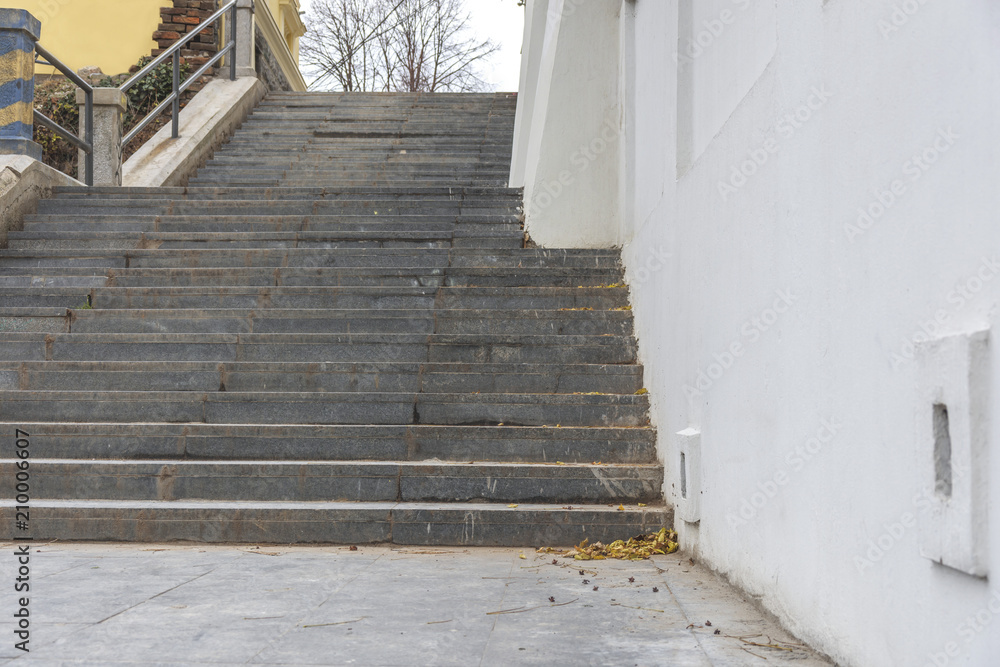 Fototapeta premium Marble damage and dirty stairs with whitehouse wall in the city