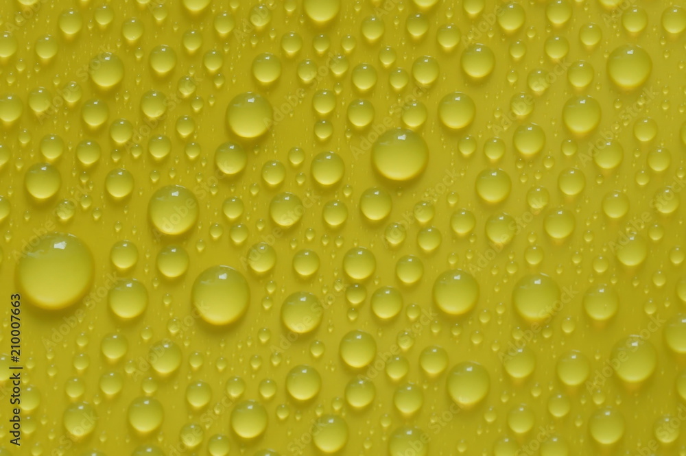natural water drops on yellow background texture natural water drops on yellow background texture