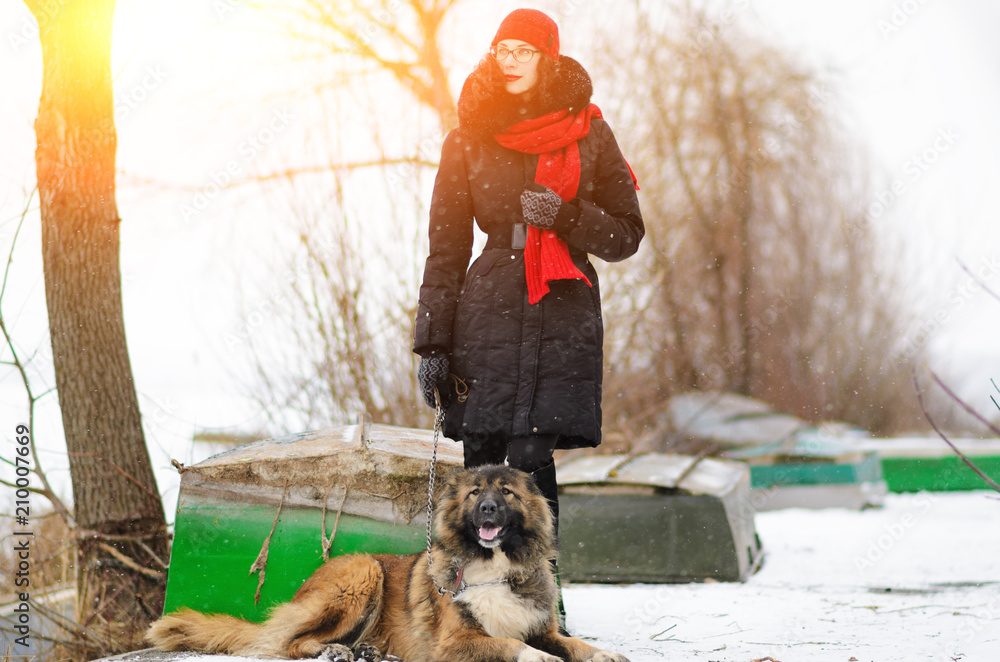 Girl playing with Caucasian shepherd dog, autumn