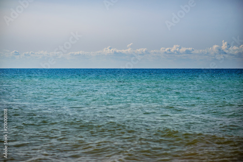 the blue ocean with dull clouds on a lovely sunny day © cezarksv