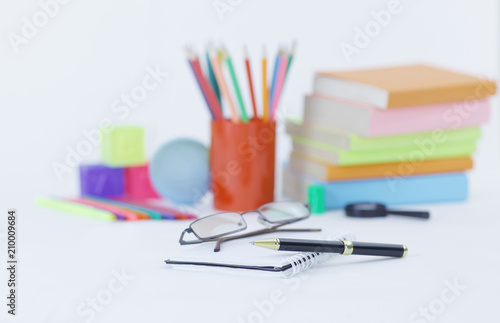 glasses ,pen and notebook on the background of school supplies .photo with copy space