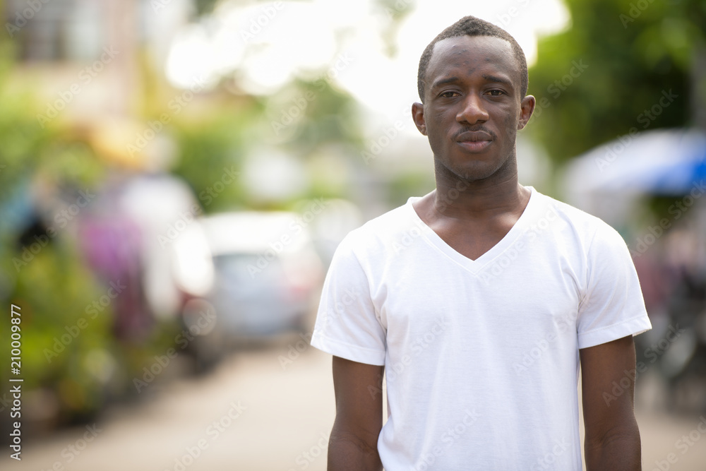 Young African man in the streets outdoors