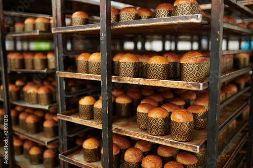 Trays rack with freshly baked delicious pastry at confectionery factory. 