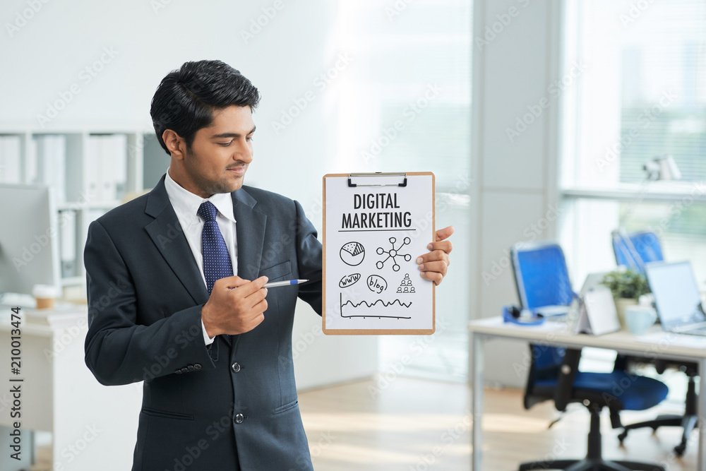Young businessman presenting new marketing plan at office Young businessman presenting new marketing plan at office