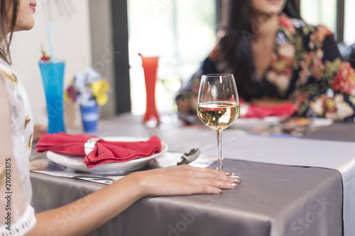 Close-up of hands holding champagne flutes during celebration on dining table
