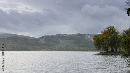 Autumnal colours and gathering rain clouds on Loch Lomond, Scotland