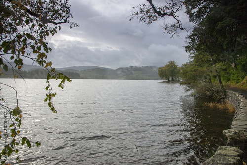 Autumnal colours and gathering rain clouds on Loch Lomond, Scotland photo