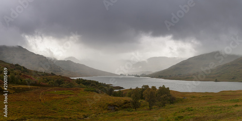 Panorama view of Loch Arklet with gathering autumnal storm clouds and the first signs of rain, near Stronachlachar, Loch Lomond & The Trossachs National Park, Scotland