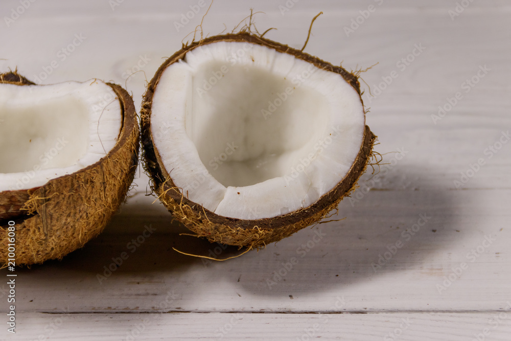 Fresh ripe coconut on white wooden table Fresh ripe coconut on white wooden table