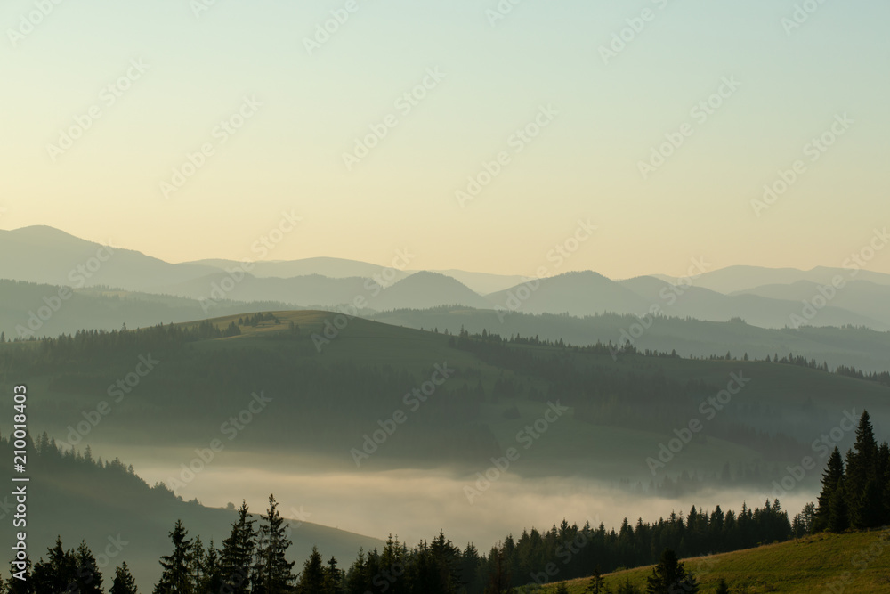 Beautiful early morning with fog between mountains